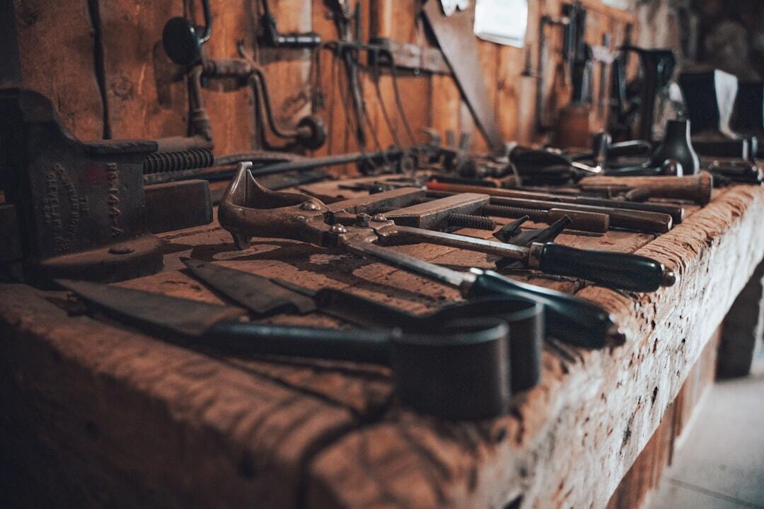 closeup of tools on a tool bench and wall in a workshop