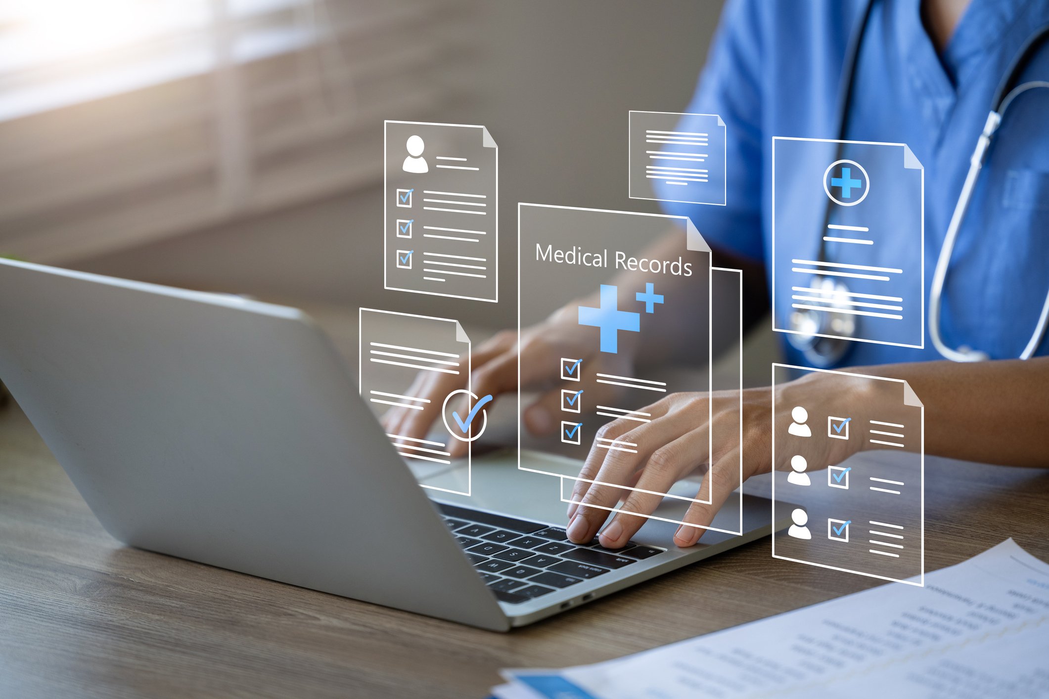 laptop with abstract images of healthcare records