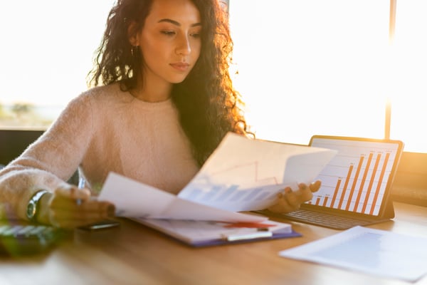businesswoman analyzing charts and graphs in a sunlit room