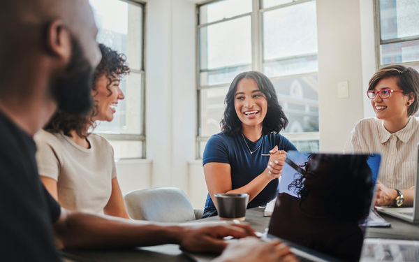 young professionals laughing at a meeting
