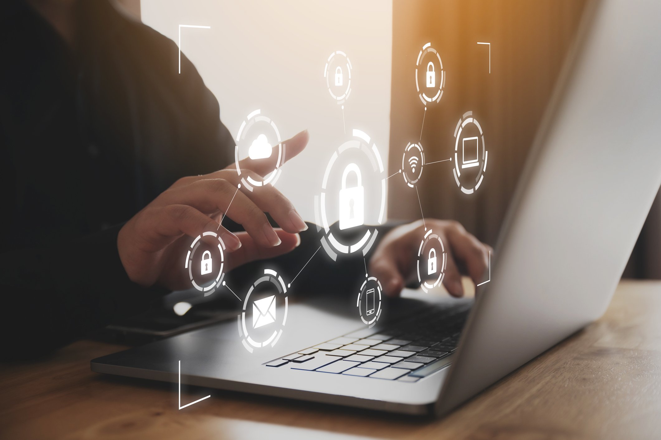 laptop with light projection of icons representing secure connections