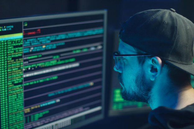 man wearing eyeglasses looking at security dashboard