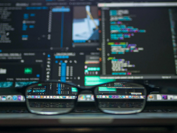eyeglasses reflecting computer code on a monitor 