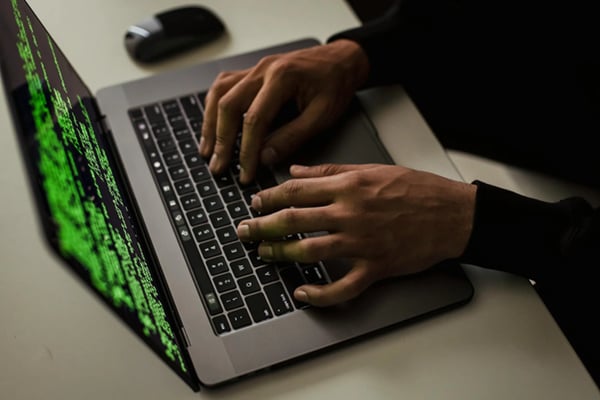 hands typing on laptop keyboard