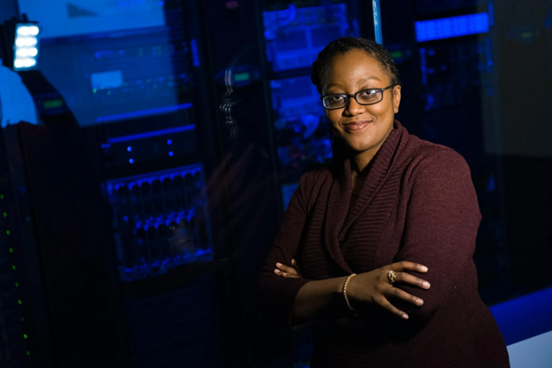 Software Engineer Standing Beside Server Racks