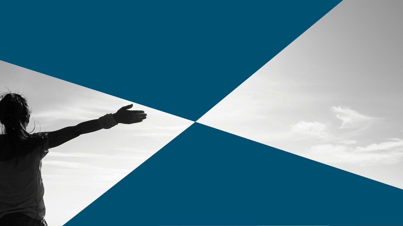 back view of person with arm extended looking at clouds